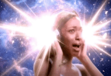 a woman is wearing headphones with a light coming out of her eyes .