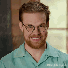 a man with glasses and a beard is smiling in a youtube originals advertisement