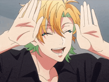 a boy with yellow hair and green hair is making a funny face with his hands