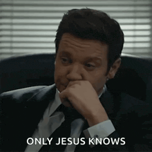 a man in a suit and tie is sitting in a chair with his hand on his chin and the words `` only jesus knows '' .