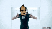 a man in a green shirt with a pixelated face on his face .