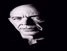 a black and white photo of a bald man