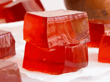 a close up of a stack of red jelly cubes