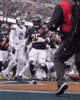 a football player with the number 25 on his jersey runs on the field