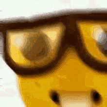 a close up of a pair of glasses on a yellow object .