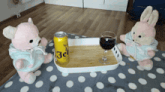 two teddy bears sitting next to a tray with a can of beer and a glass of wine on it