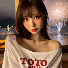 a woman wearing a toto macau shirt stands in front of a firework display