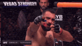 a fighter in a cage with vegas stronger written on the bottom