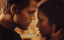 a man and a woman are kissing each other and the woman is saying `` twin '' .