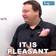 a man is holding a stuffed animal and says it is pleasant