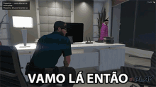 a man sitting at a desk in a video game with the words vamo la entao in play