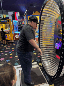 a man playing a game in an arcade with a machine that says just jack