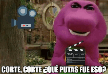 a purple stuffed animal is holding a clapper board and says " corte corte "