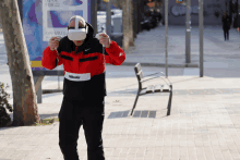 a man wearing a virtual reality headset stands in front of a billboard that says feb 22