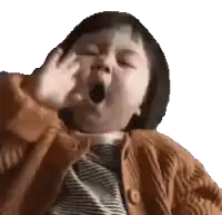 a little girl is yawning with her hand on her face