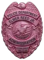 a pink badge from the police department elmer reed jr. administration