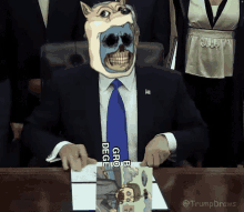 a man in a suit and tie is sitting at a desk with a drawing of a skull on his face