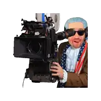 a man in an american flag outfit is holding a video camera