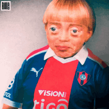 a young boy wearing a blue red and white shirt with the word vision on it