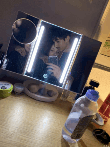 a bottle of micellar water sits on a counter next to a mirror