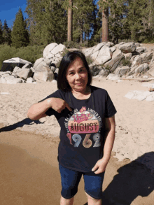 a woman wearing a black t-shirt that says august 1962