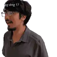 a man wearing glasses and a grey shirt has a watermark that says dmg 17