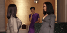 a woman in a purple dress is covering her mouth