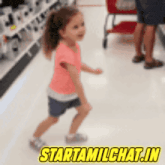 a little girl is dancing in a store with the words starttamilchat.in