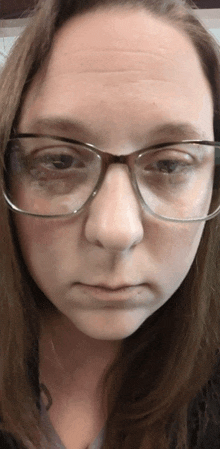 a close up of a woman 's face with glasses