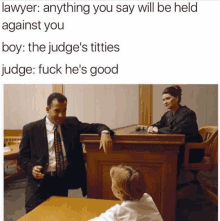 a man in a suit is talking to a young boy in a courtroom