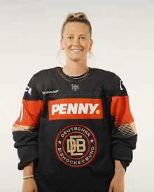 a woman wearing a jersey that says penny