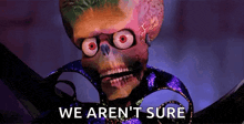 a skeleton with glasses and red eyes is holding a pair of scissors and says `` we aren t sure '' .