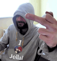 a man wearing a hoodie that says " i love jellal "