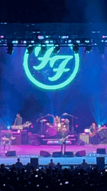 a group of musicians are on stage with a large k7 logo on the stage