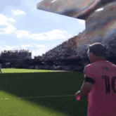 a man wearing a pink shirt with the number 10 on the back