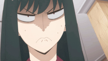 a close up of a woman 's face with a very angry look on her face