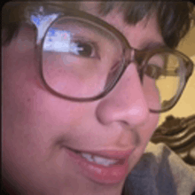 a close up of a person 's face wearing glasses .