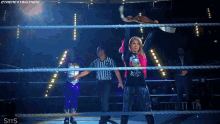 a woman in a wrestling ring is wearing a shirt that says ' the next big thing ' on it