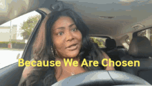 a woman in a car with the words " because we are chosen " on the screen