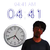 a man with glasses stands in front of a clock that says 04 41 am