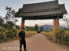 a huawei p30 pro leica quad camera takes a picture of a man in front of a wooden archway