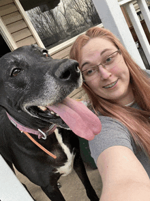 a woman taking a selfie with a black and white dog