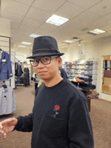 a man wearing a hat and glasses stands in a store