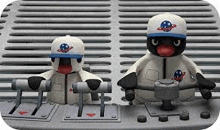 two penguins are sitting next to each other on a machine .