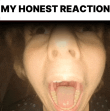 a close up of a woman 's face with her mouth open and the words " my honest reaction " above her