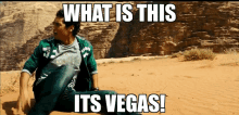 a man is sitting in the sand with the words what is this its vegas