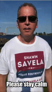 a man wearing a shirt that says shawn savela on it