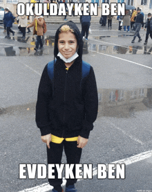 a young boy wearing a mask and a black jacket with the words okuldayken ben evdeyken ben