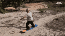 a young boy is riding a snowboard down a sandy hill and the words awesome are on the bottom right