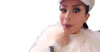 a close up of a woman wearing a white hat and a white fur coat .